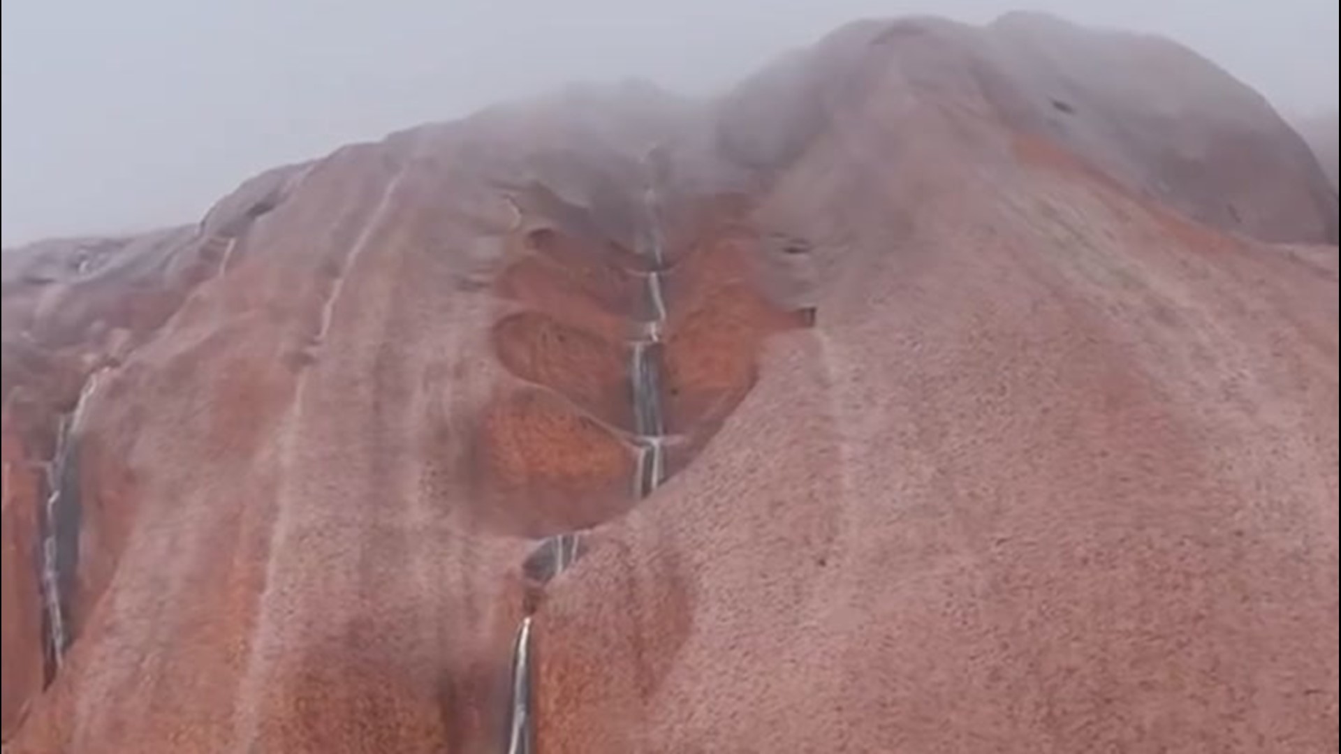 Rare Rain Cascades Down Australia S Iconic Uluru Monolith 9news Com