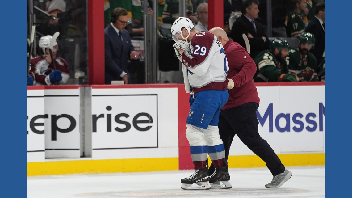 MacKinnon takes a puck from an Avs teammate to the face