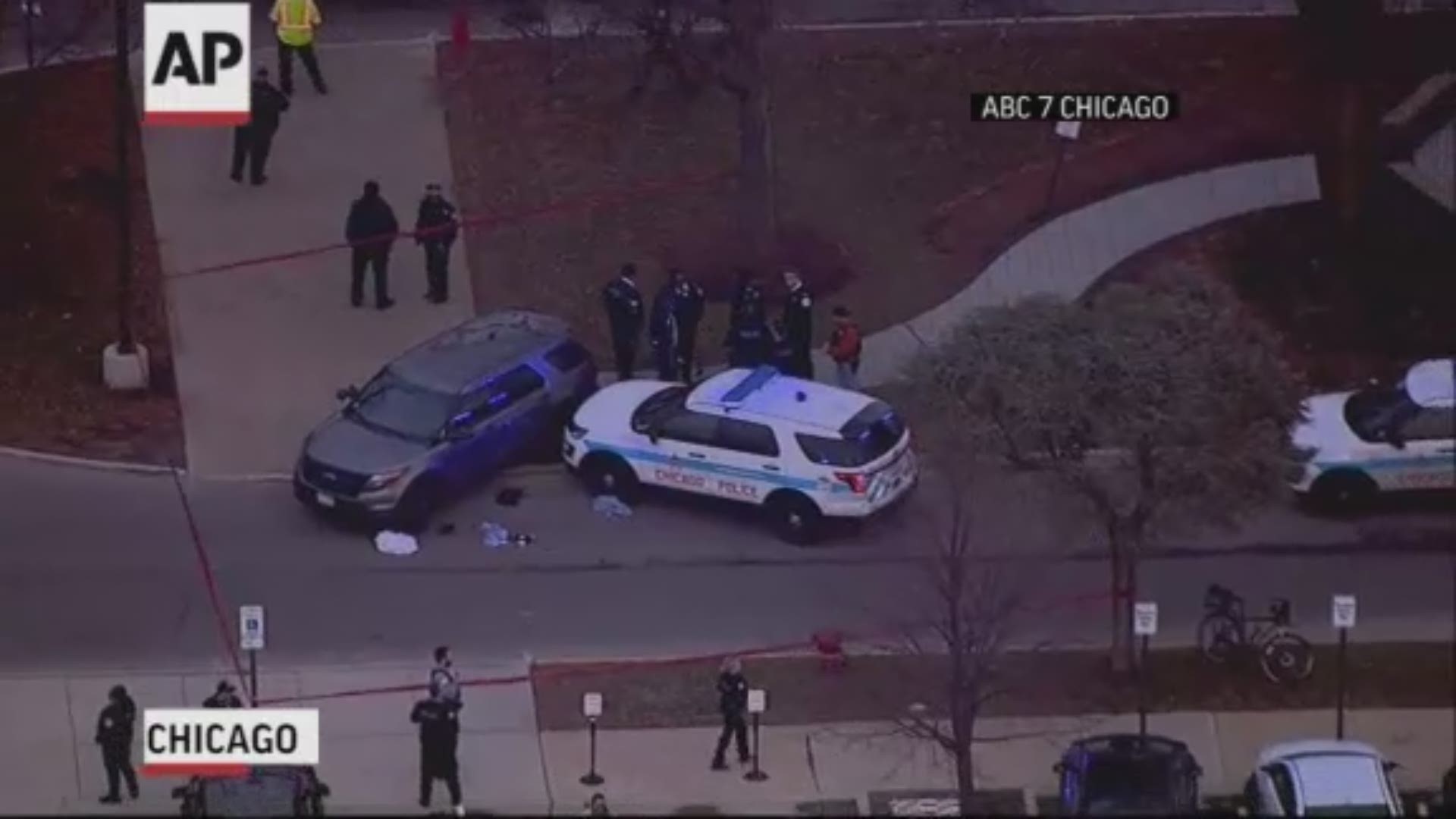 Police in Chicago say a suspected gunman is dead and an officer and three others are in critical condition in a shooting at a hospital in the city. (ABC 7 Chicago via AP)
