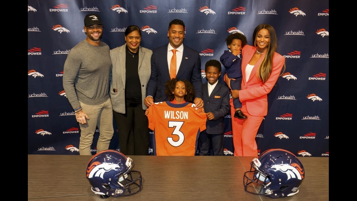 Denver Broncos quarterback Russell Wilson (3) greets, from left to right,  his daughter Sienna, wife and rap star Ciara, and sons Future and Win  before taking part in drills during the NFL