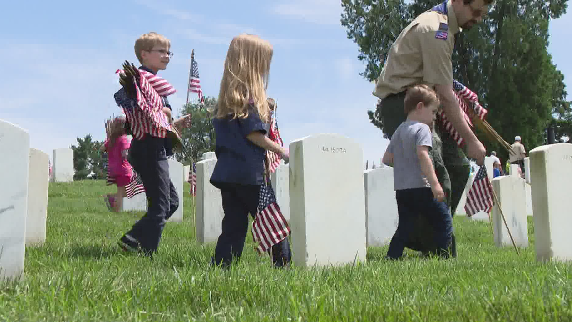 During the annual event, thousands of scouts plant American flags at the gravesites of more than 100,000 veterans