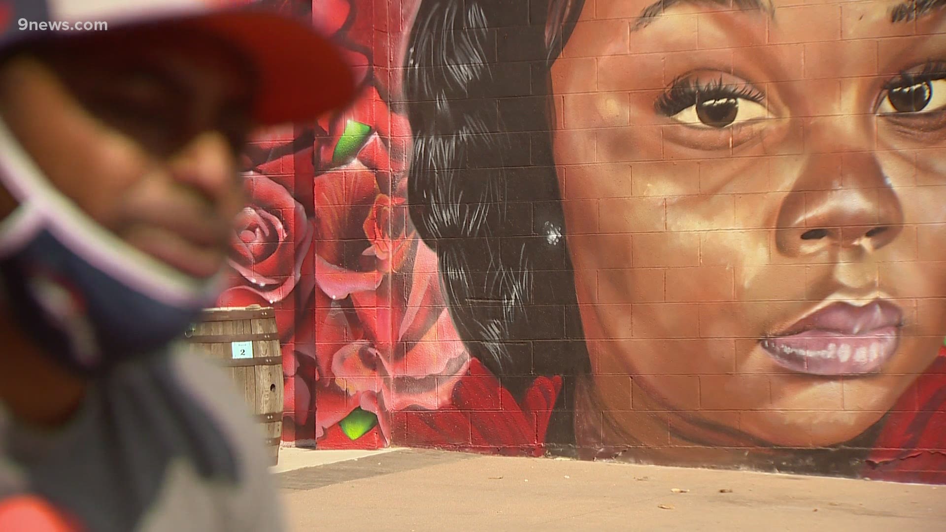A Denver mural of Breonna Taylor was visited by people honoring her name and memory.