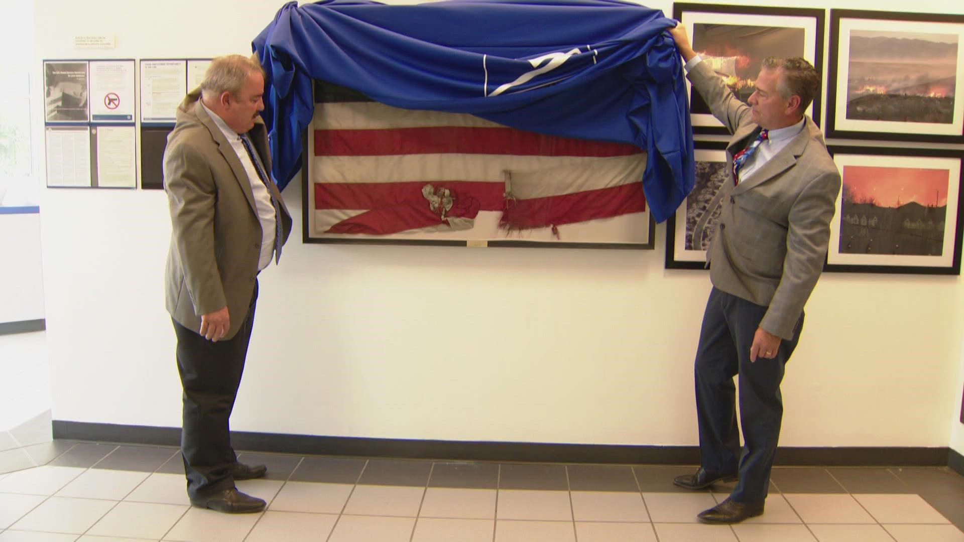 The flag flown over the Superior post office on the day of the Marshall Fire is now on display. The community sees it as a symbol of hope.