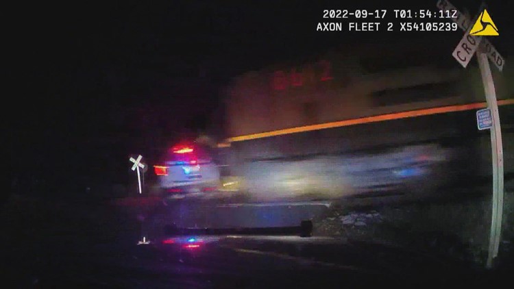 Video shows train hitting police cruiser with suspect inside