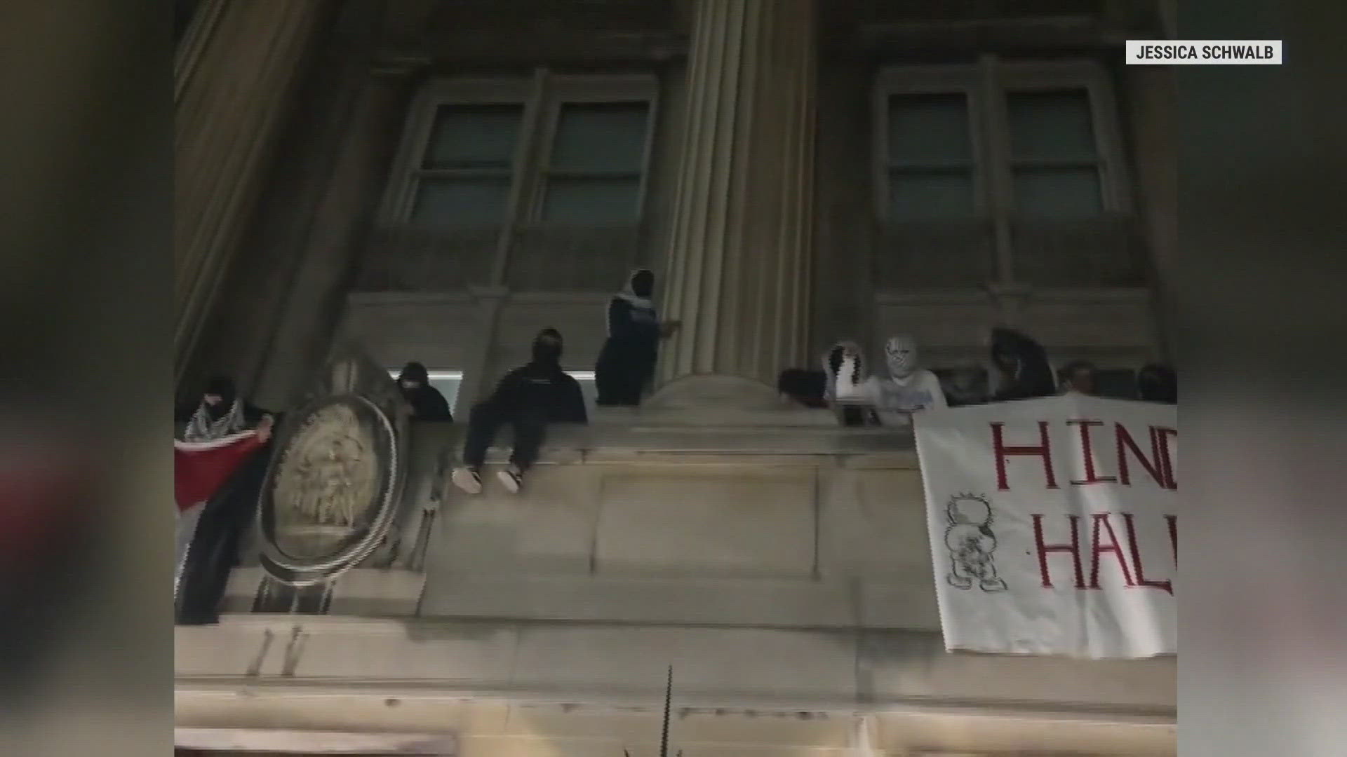 Dozens of protesters took over a building at Columbia University in New York early Tuesday, barricading entrances and unfurling a Palestinian flag from a window.