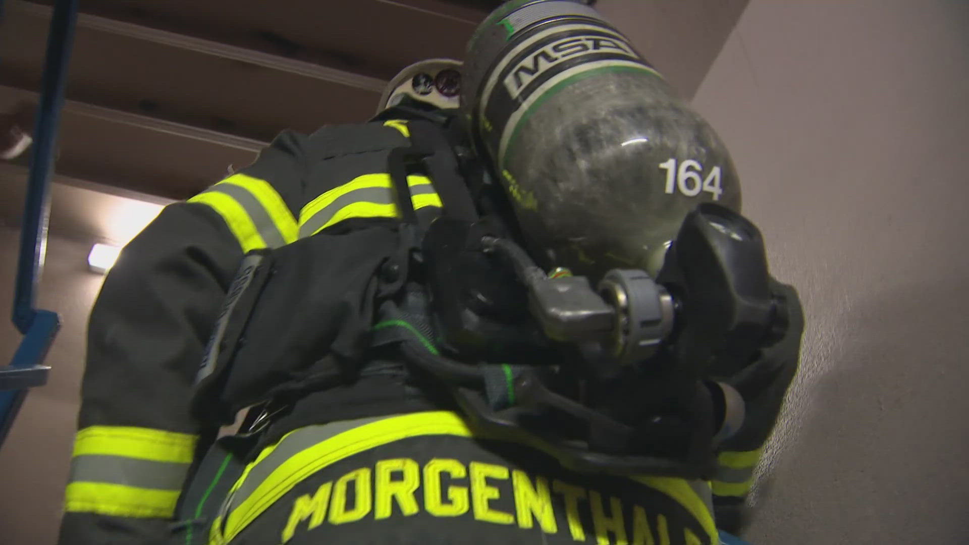 Colorado firefighters climbed Denver's second-tallest building twice Wednesday to honor the firefighters killed in the Sept. 11 attacks.