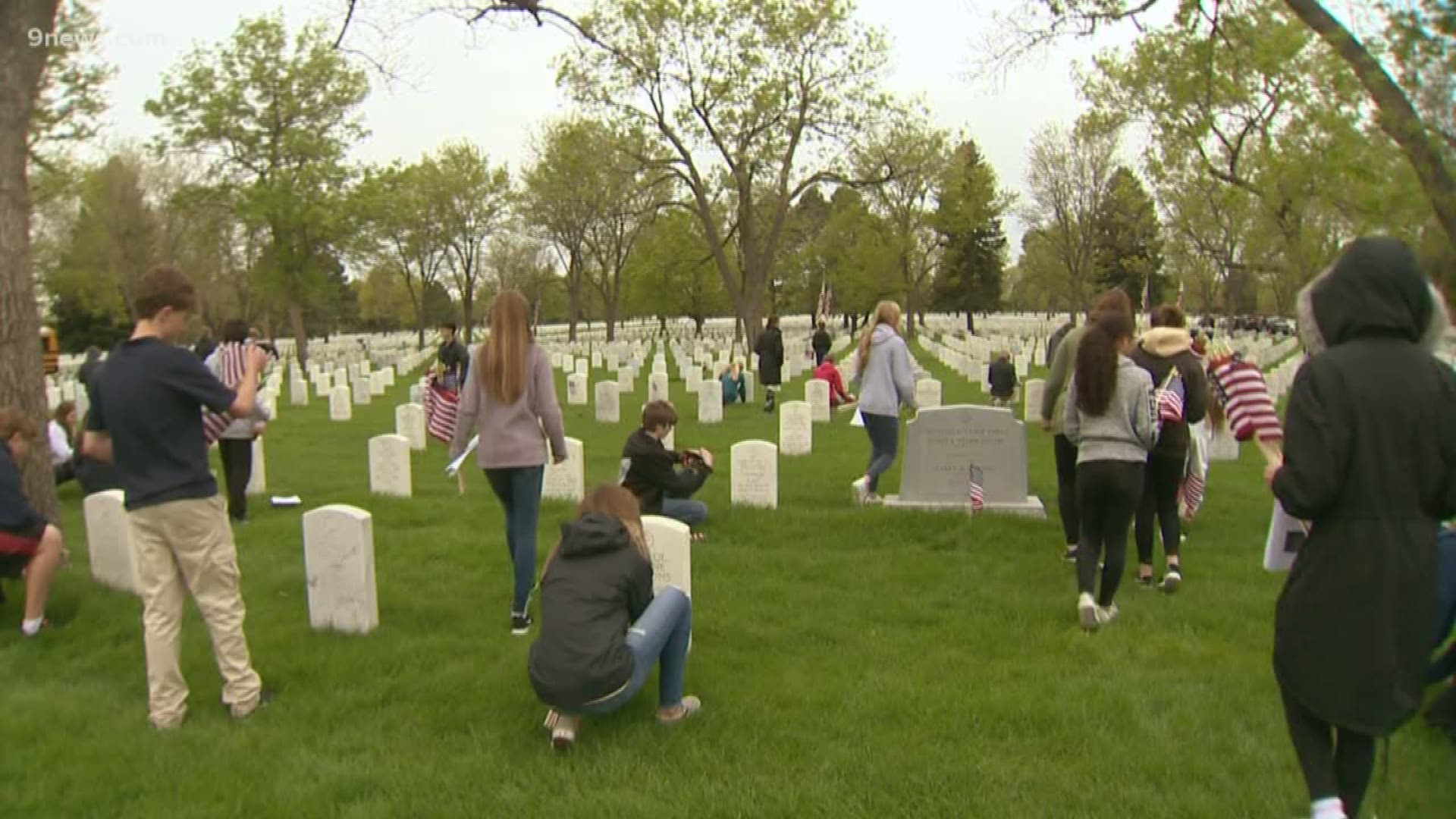 On the last day of school, eighth graders from West Middle School in Greenwood Village place flags on the graves of soldiers and their families as the end of a yearlong history lesson entitled, “Freedom isn’t free”.