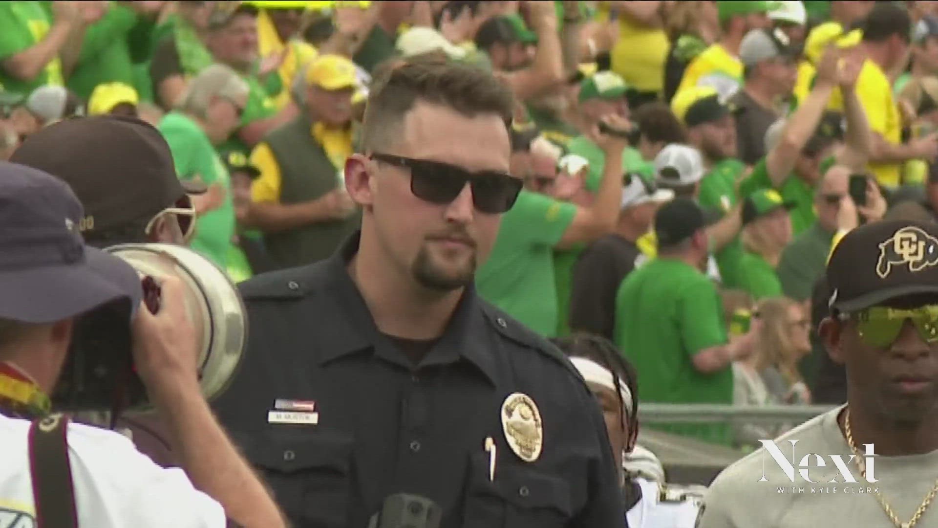 Officer Marc Mustoe says, "I was protecting the quarterback back then. Now I'm protecting a university."