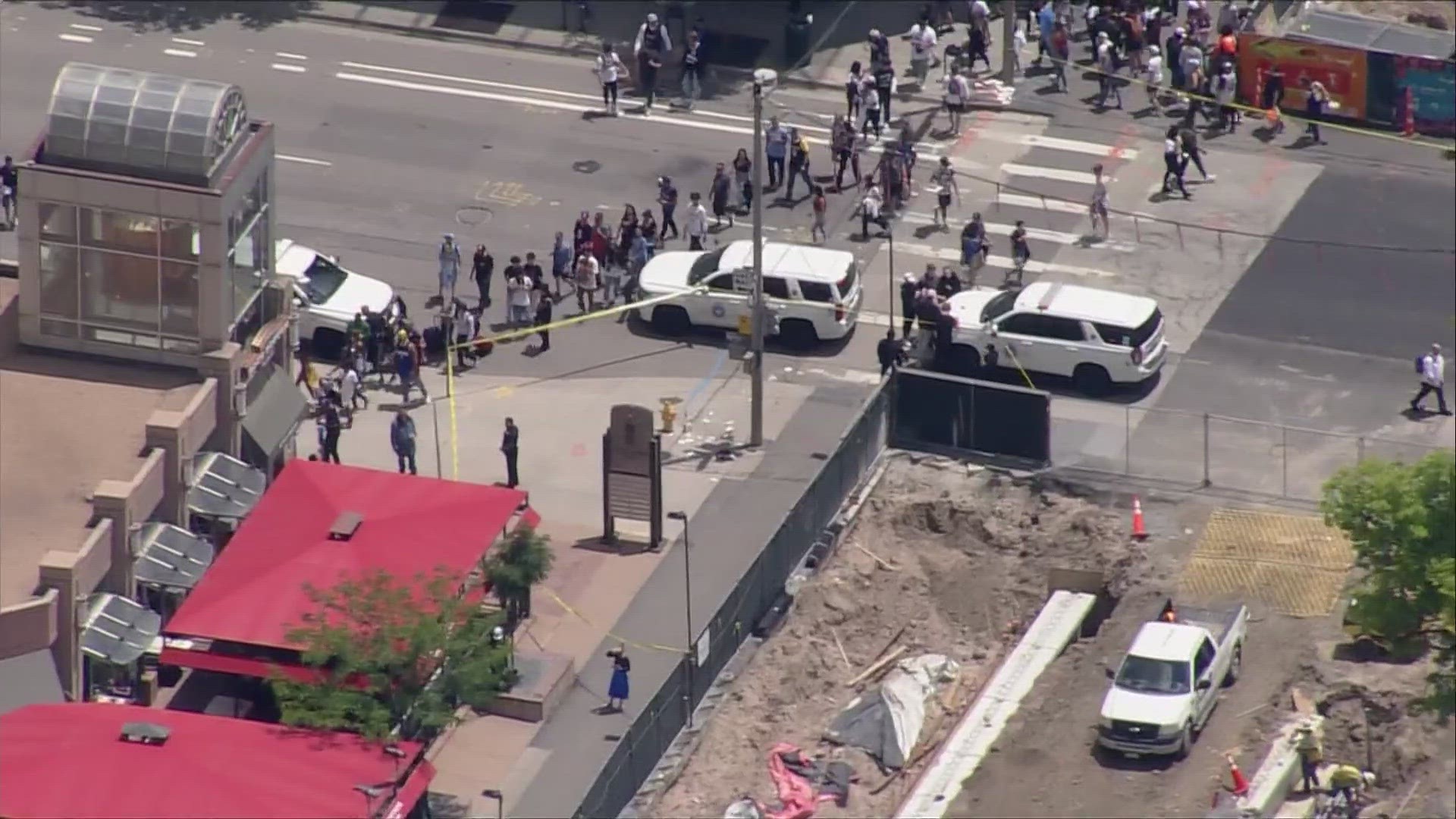 Shortly after police rushed that officer to the hospital - and while they were still trying to handle parade crowds - a shooting hurt two people in Downtown Denver.