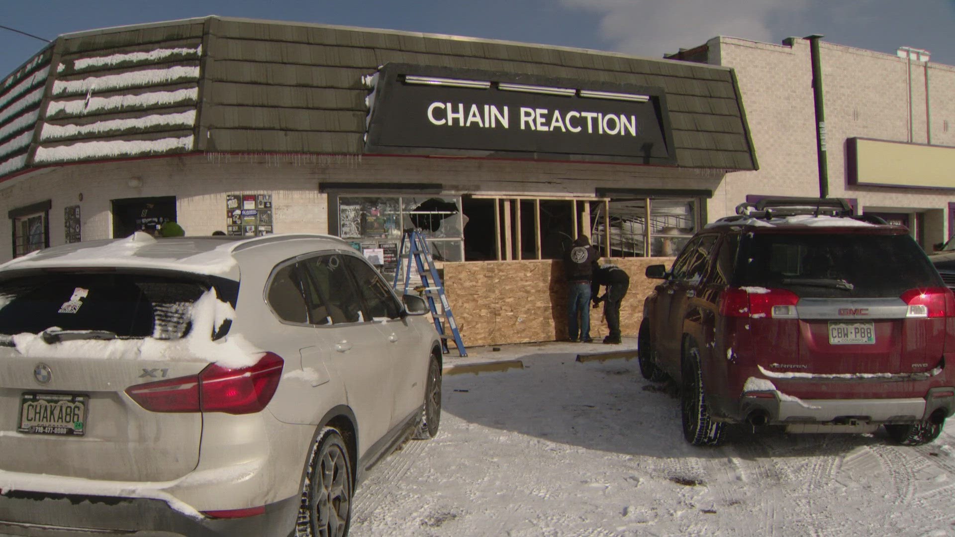 Lakewood Police said investigators were able to follow tire tracks in the snow from a second crash scene to Chain Reaction Records, which was heavily damaged.