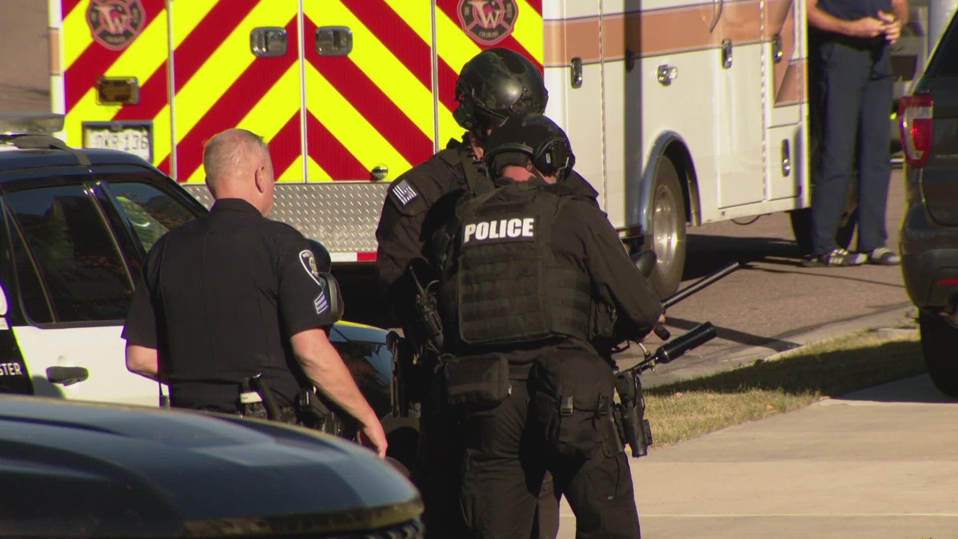 A woman is in custody and two law enforcement officers are hurt following an hours-long standoff in Westminster.