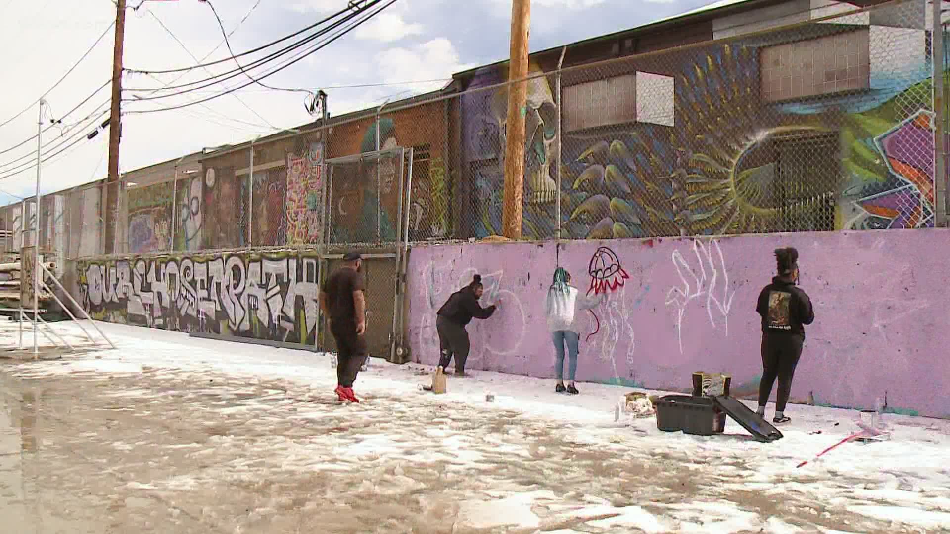 Murals done by local Black artists are starting to go up on loading docks near 29th Street and Blake Street in downtown Denver.