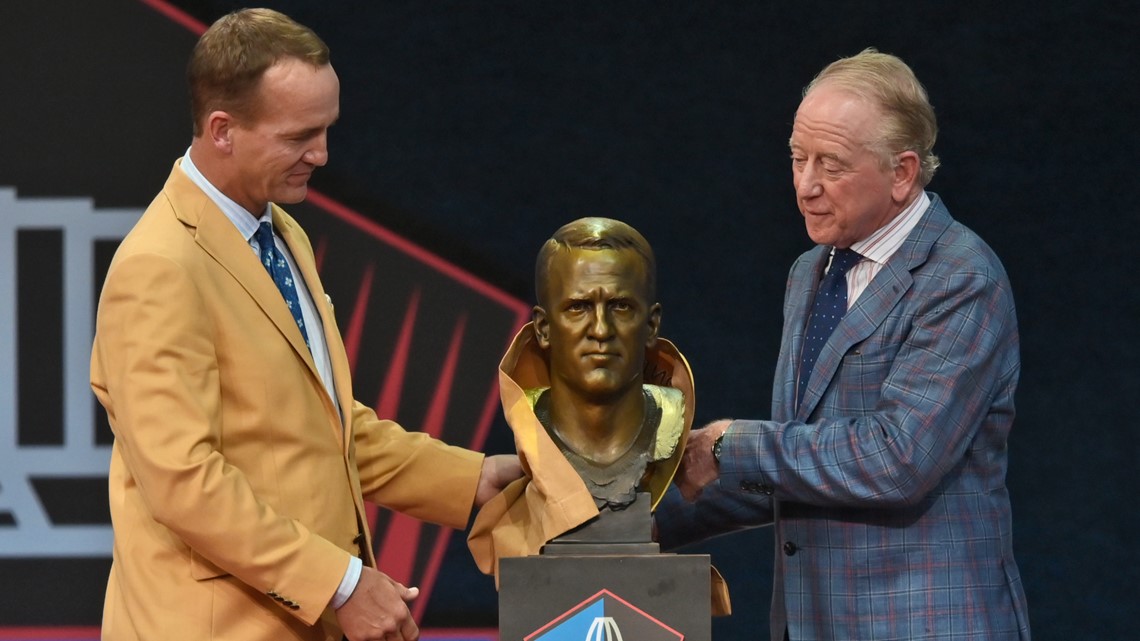 Archie Manning, right, watches his son., Denver Broncos