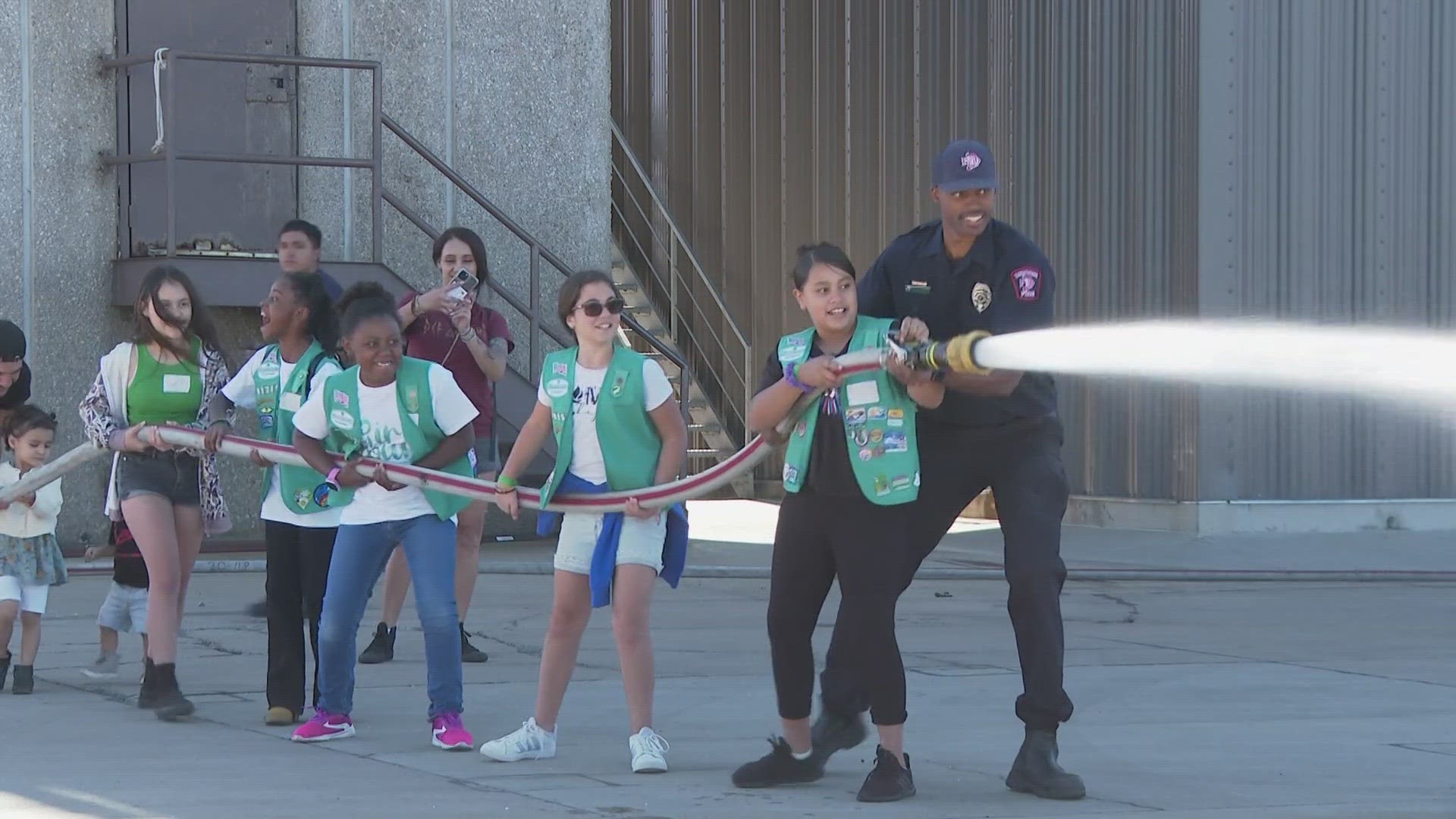 Firefighters from the Denver Fire Department held an event teaching kindergarten through 8th grade girls about fire safety and how to get into the field.