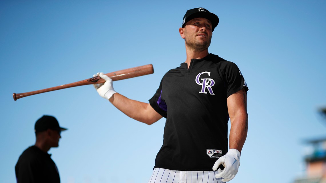 Dante Bichette of the Colorado Rockies looking on holding a bat