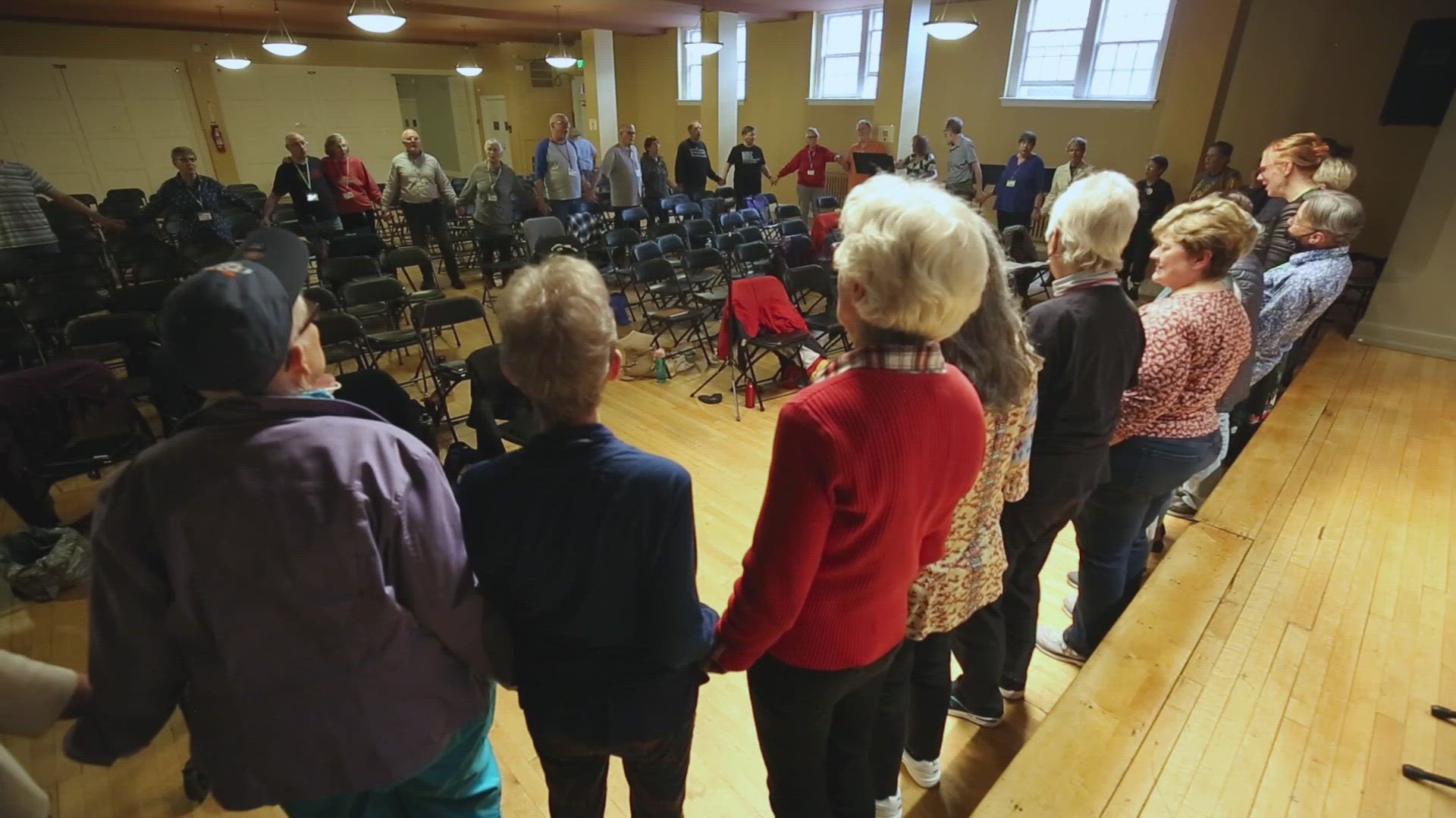 9news reporter Jaleesa Irizarry introduces to the Sage Singers.