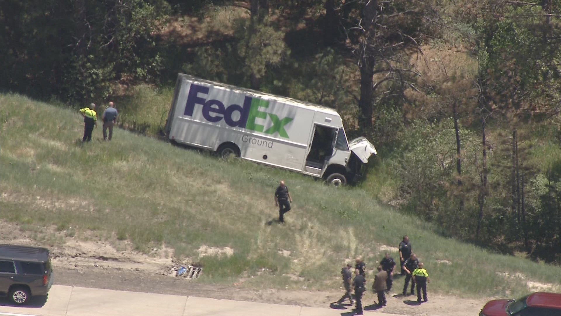 PHOTOS Stolen FedEx crashes on side of I25