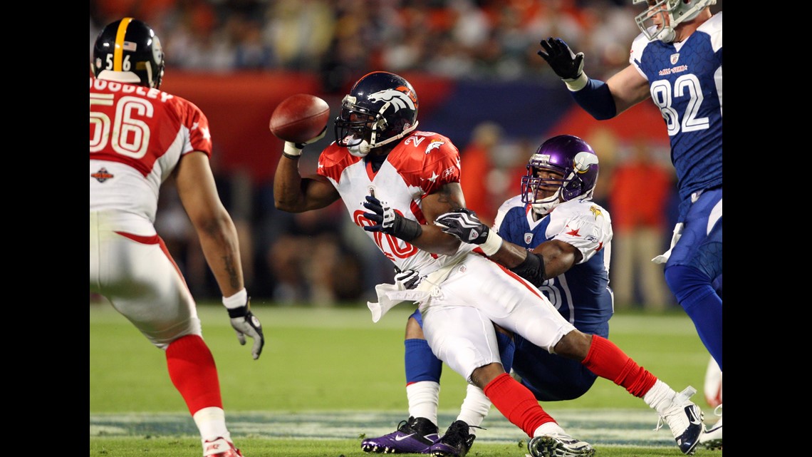 Denver Broncos safety Brian Dawkins jokes with teammates as he