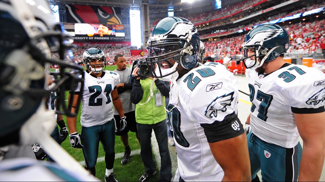 Denver Broncos safety Brian Dawkins jokes with teammates as he