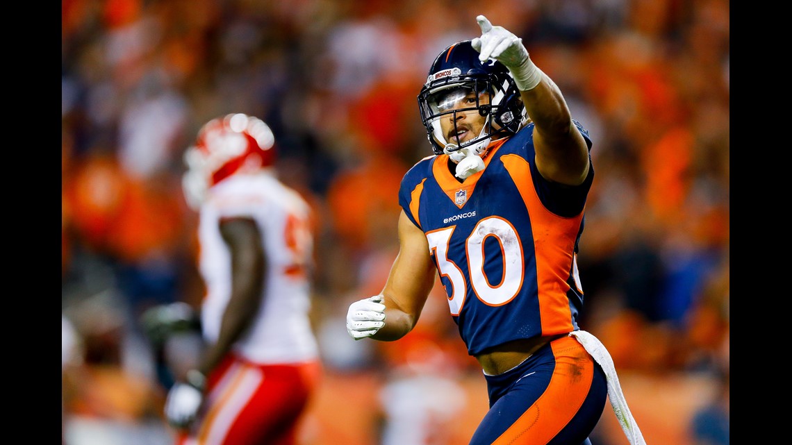 Kansas City Chiefs quarterback Patrick Mahomes makes a left handed first  down pass to wide receiver Tyreek Hill as Denver Broncos linebacker Von  Miller tries to tackle Mahomes in the fourth quarter