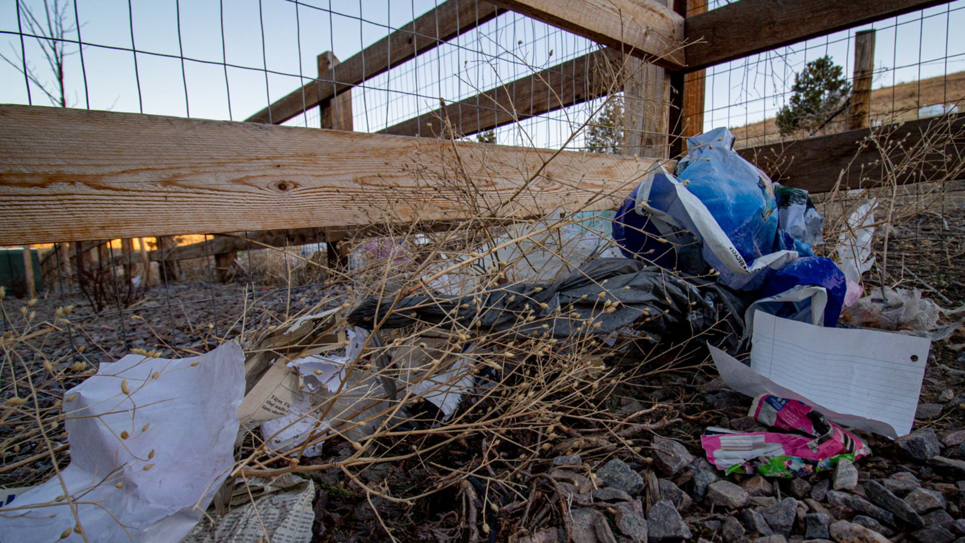 PHOTOS Residents believe trash from a nearby landfill is blowing into