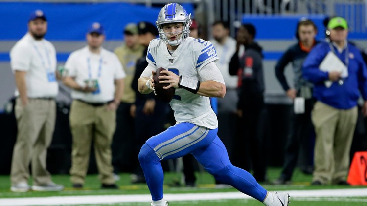 Detroit Lions quarterback Jeff Driskel (2) slides after a run as