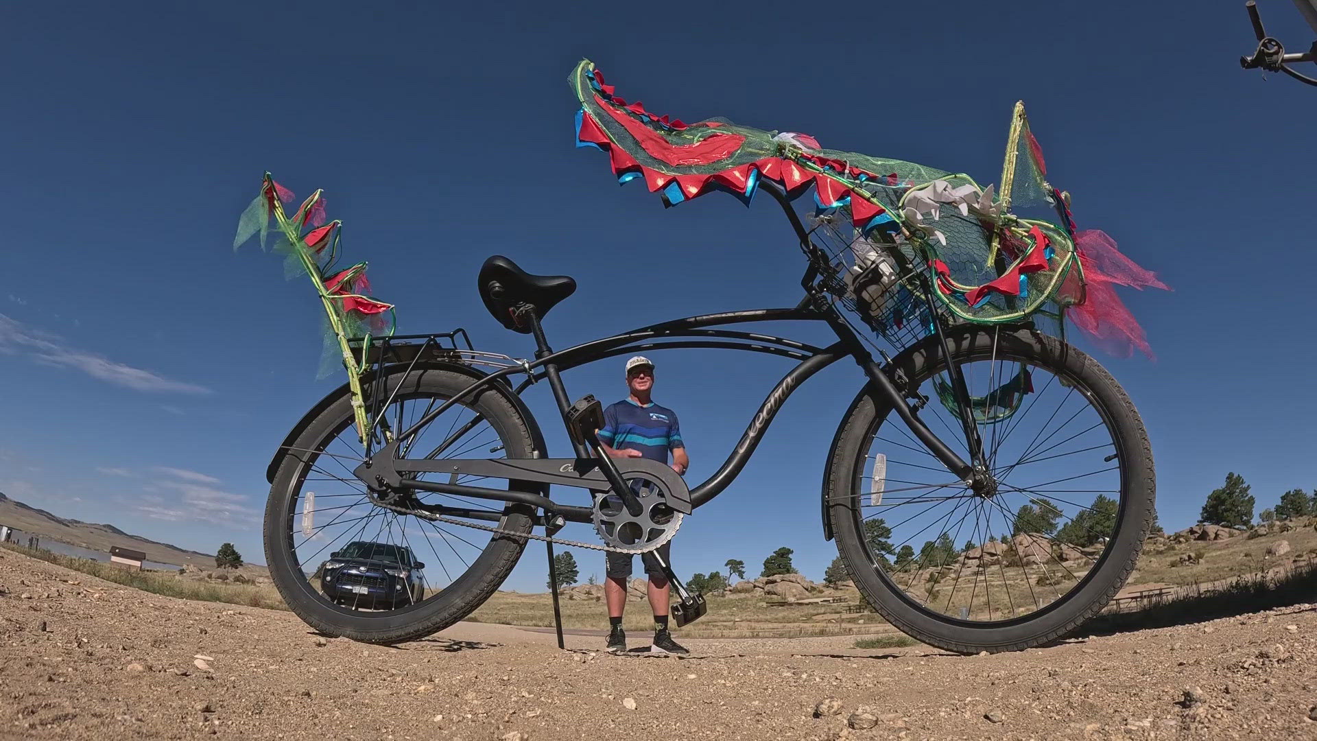 Michael Blunk is riding a single speed Cruiser bike decorated like a dragon 230 miles to raise money for the Adaptive Sports Center in Crested Butte.