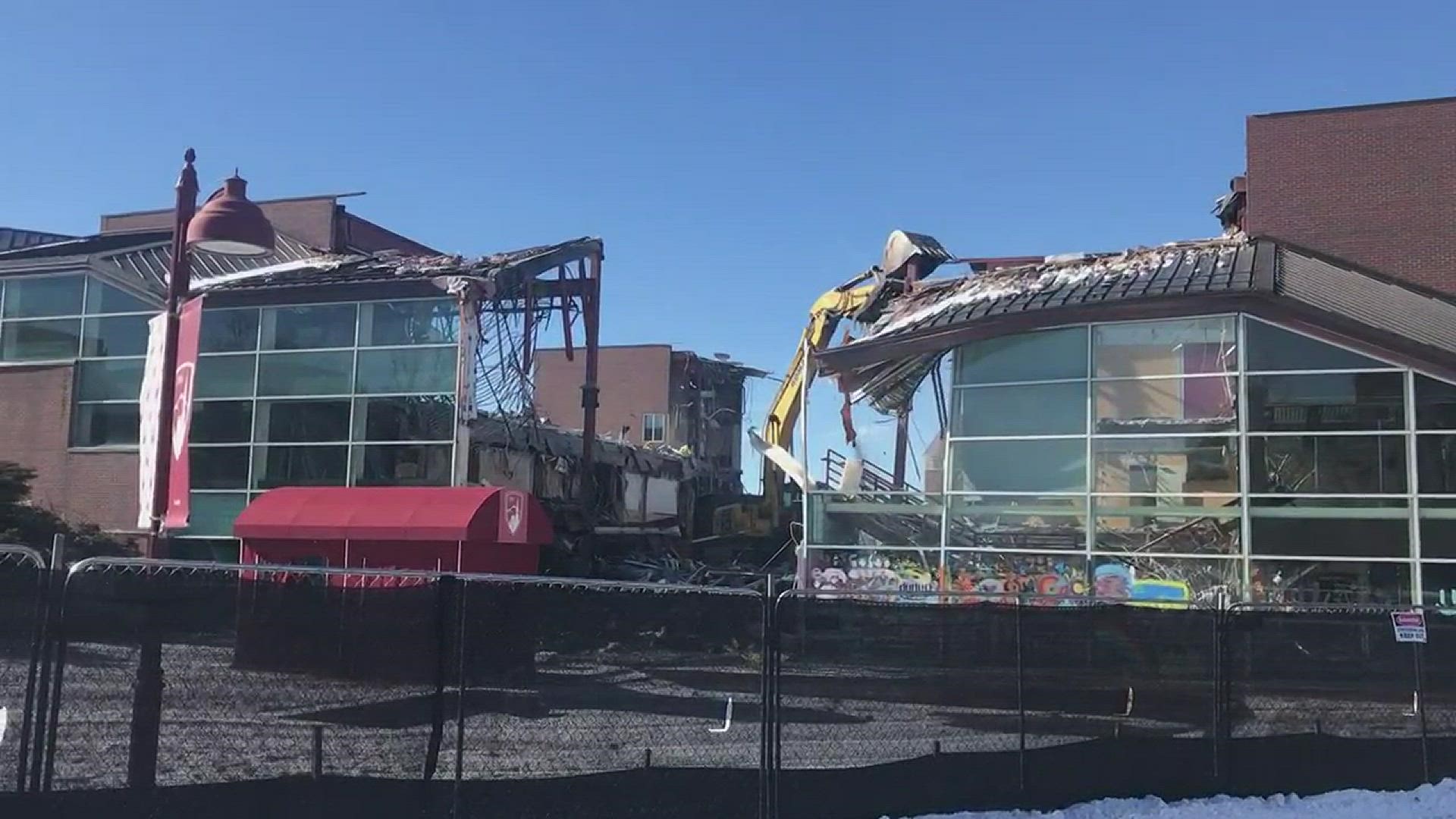 An excavator tears down the University of Denver's Driscoll Student Center as part of the university's $143 million plan to overhaul the campus