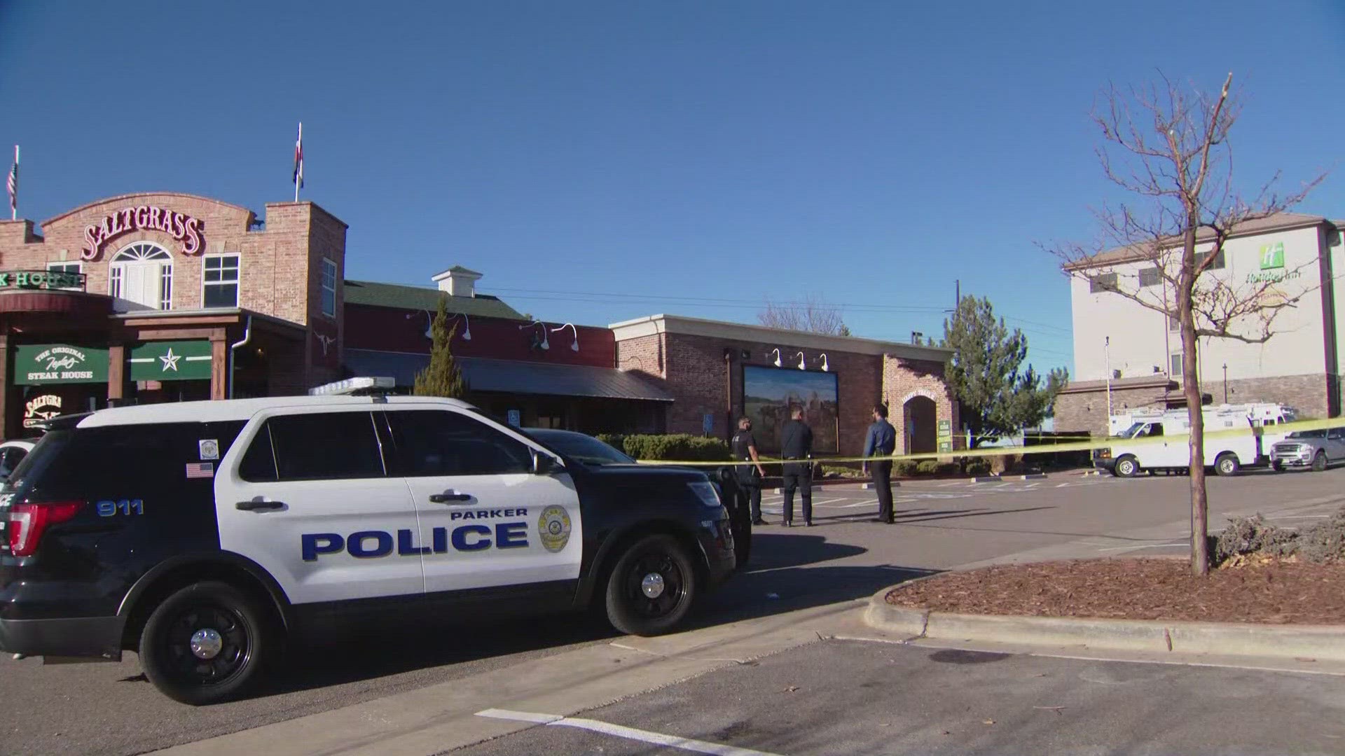 Police found the two men dead with gunshot wounds near a hotel and restaurant in Parker.