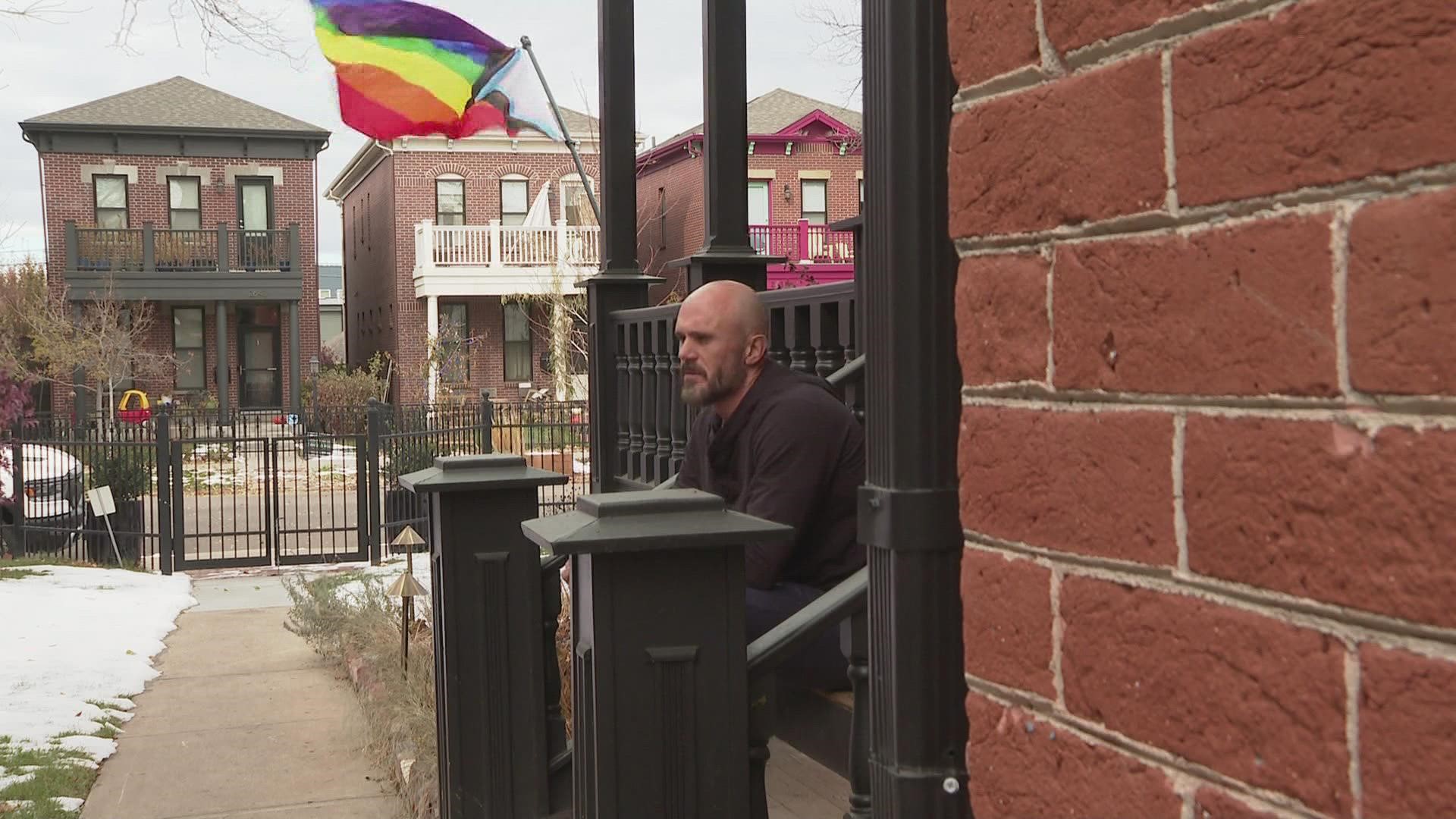 These neighbors in Denver's Curtis Park neighborhood are honoring victims in the Club Q shooting by hanging Pride flags.