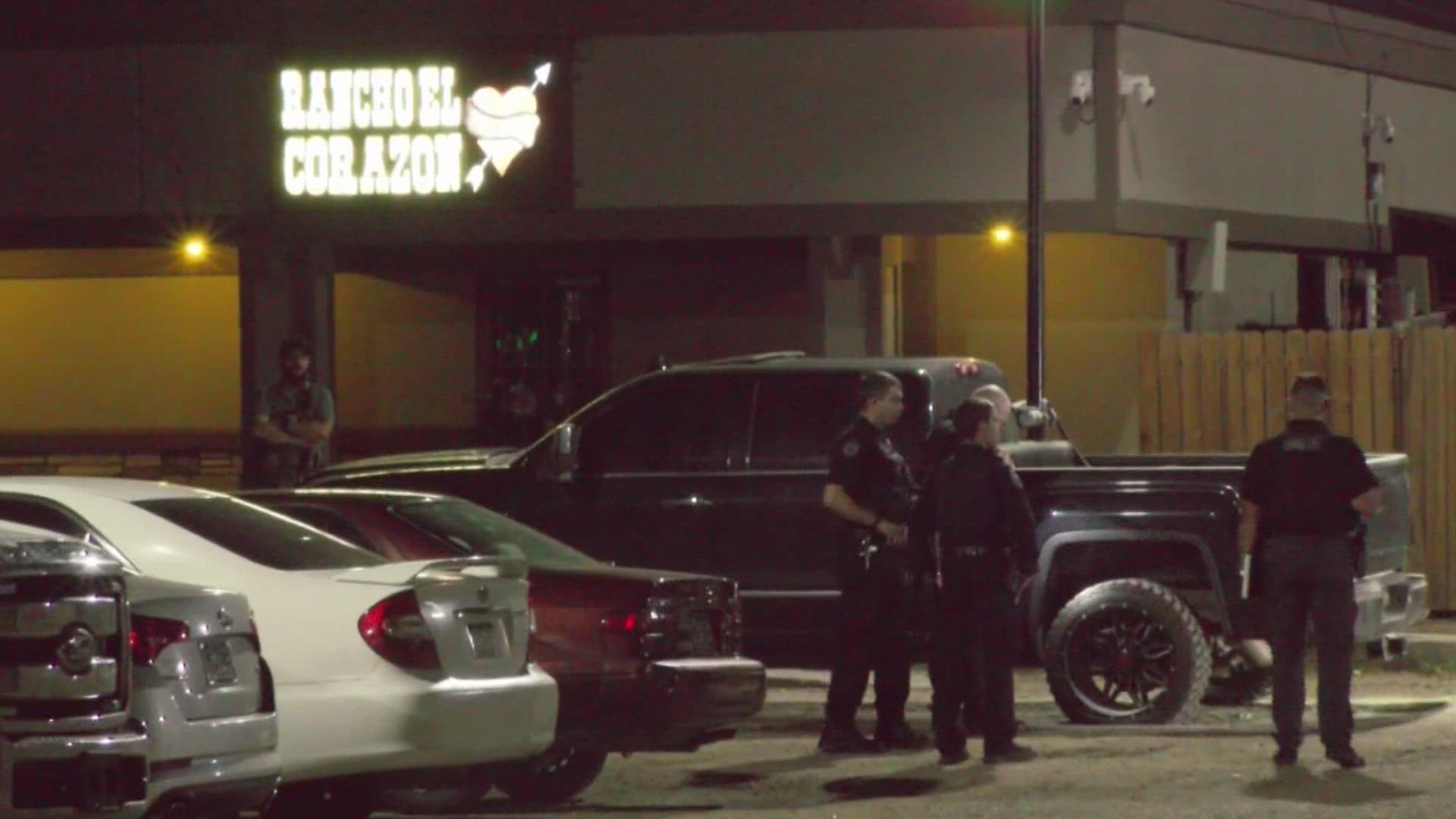 Investigators said a masked suspect arrived outside the bar in a vehicle, got out and fired dozens of rounds from a rifle at patrons standing outside.