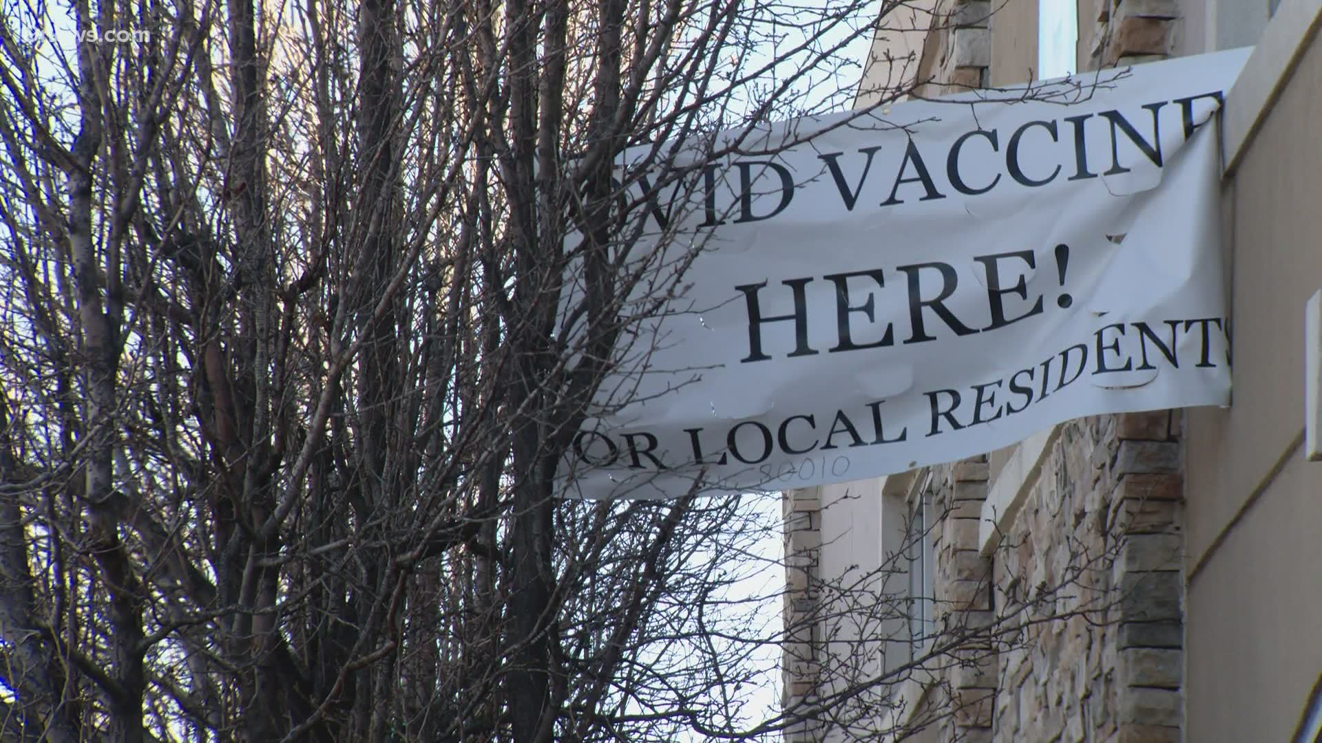 An Aurora doctor was told the banners he hung outside his clinic to bring attention to the COVID-19 vaccine are a zoning violation.