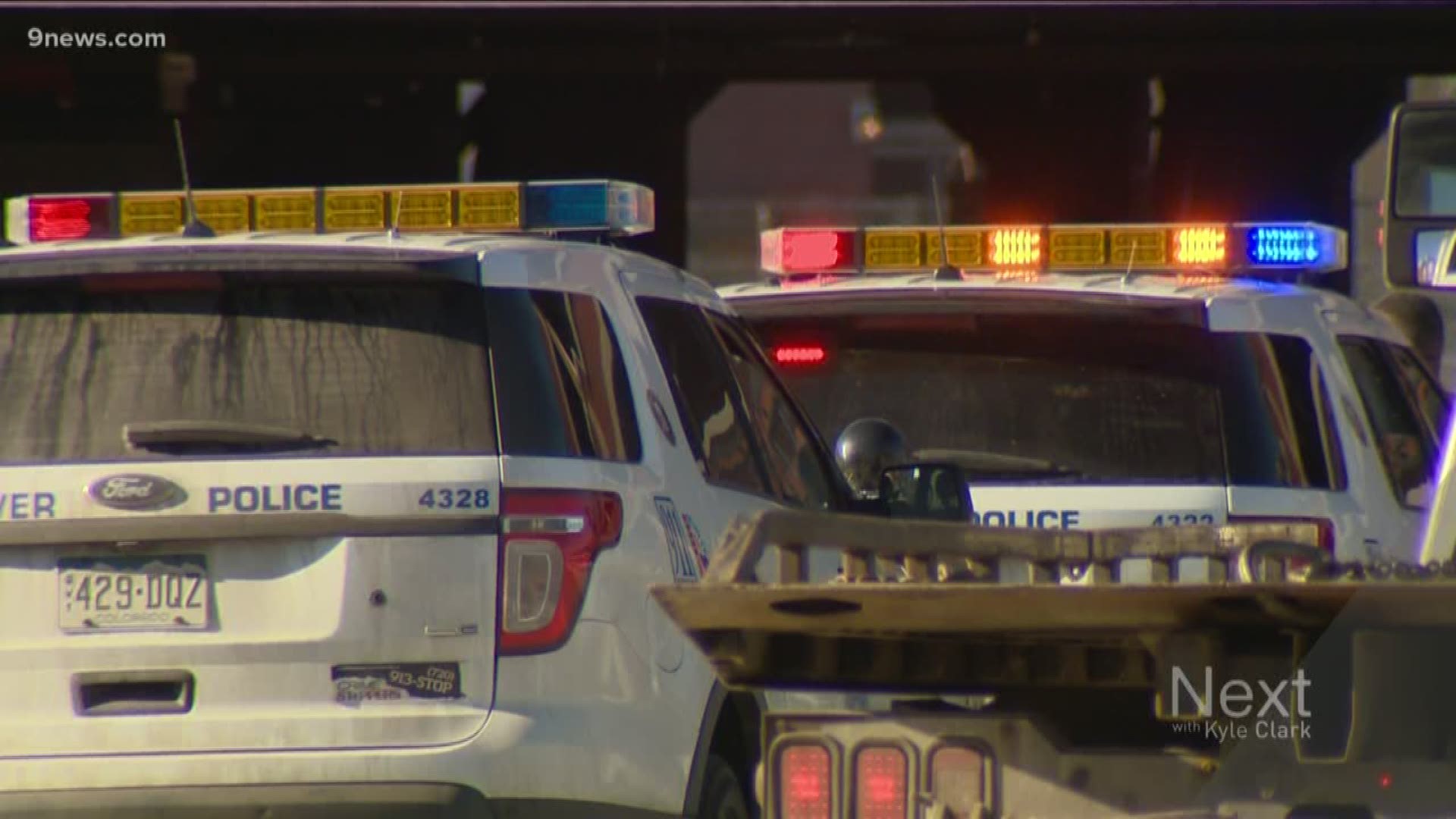 At least two vehicles in a parking garage were damaged by bullets, according to Denver Police.