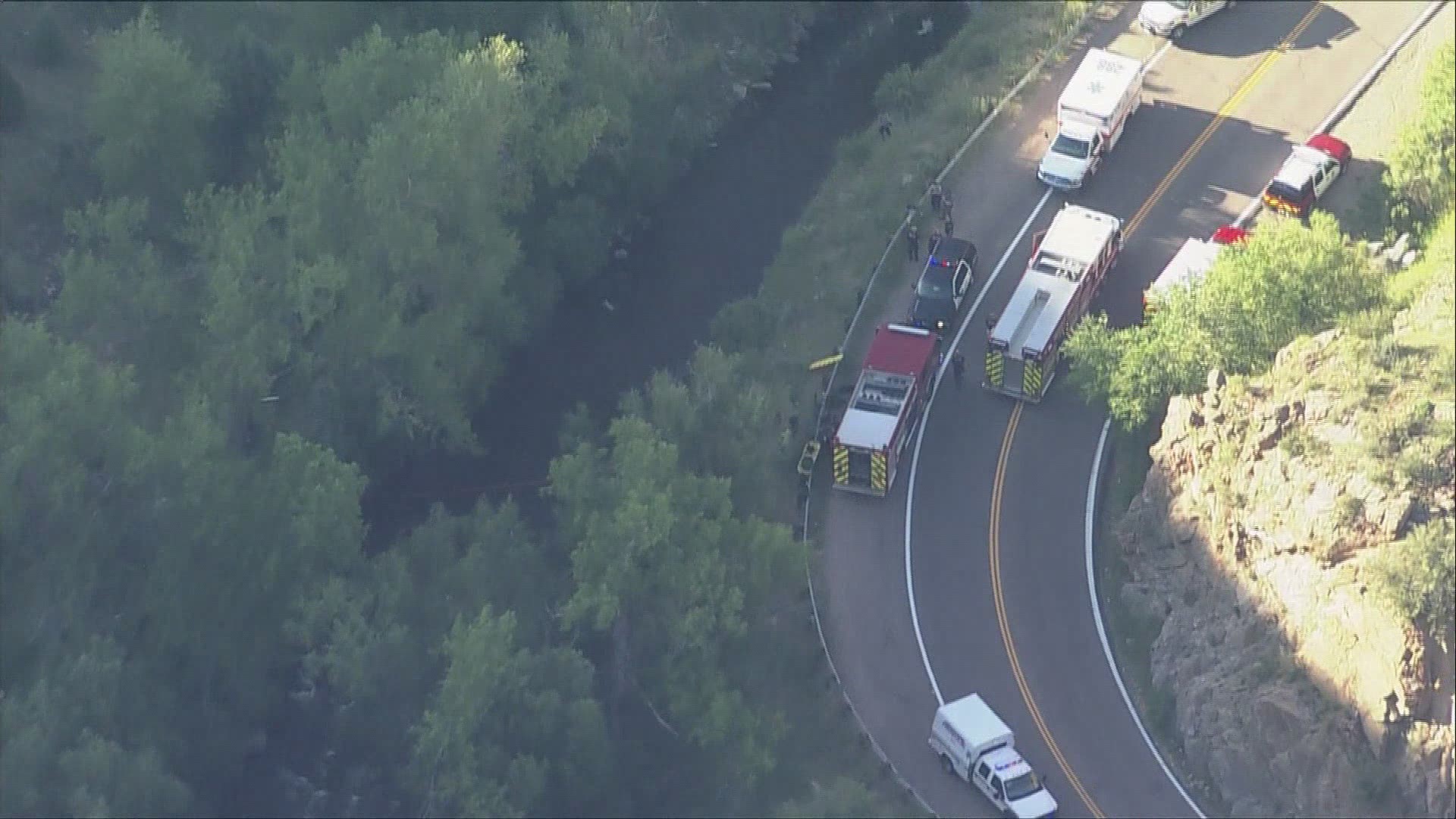 Emergency crews were working to rescue at least one person from Bear Creek after a motorcycle crash ended with someone in the water Tuesday evening.