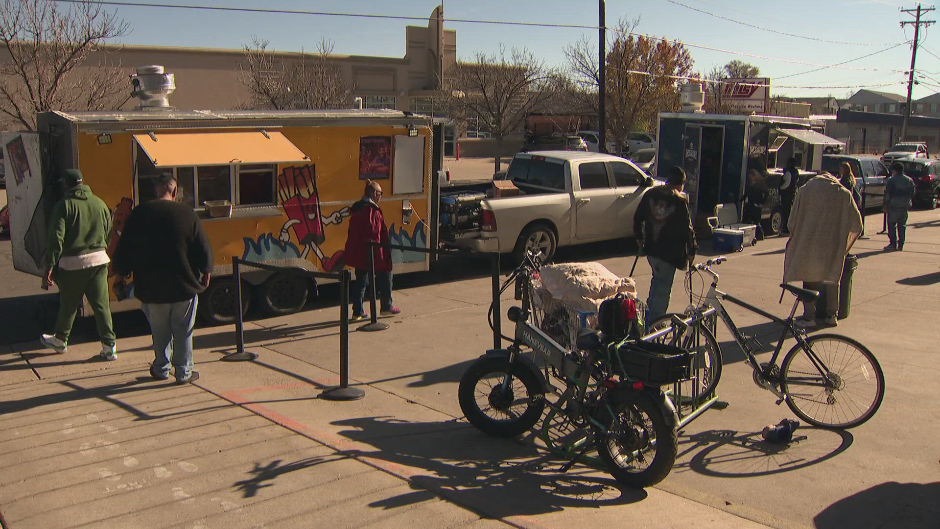 Two food trucks set up outside Recovery Works on West Colfax on Monday afternoon. They gave away free meals to those in need.