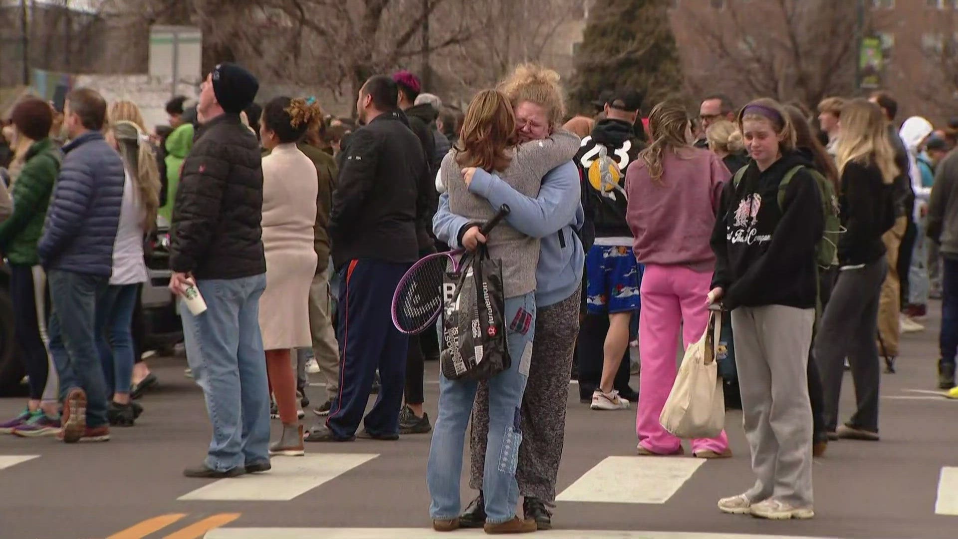 Students reunite with parents after the shooting at Denver East High school on Wednesday morning that left 2 administrators injured.