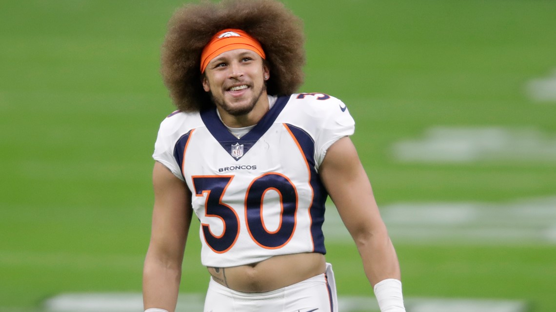 Denver Broncos running back Phillip Lindsay leaves the field after an NFL  football game against the New England Patriots while wearing a headband  with colors supporting Crucial Catch initiative, Sunday, Oct. 18