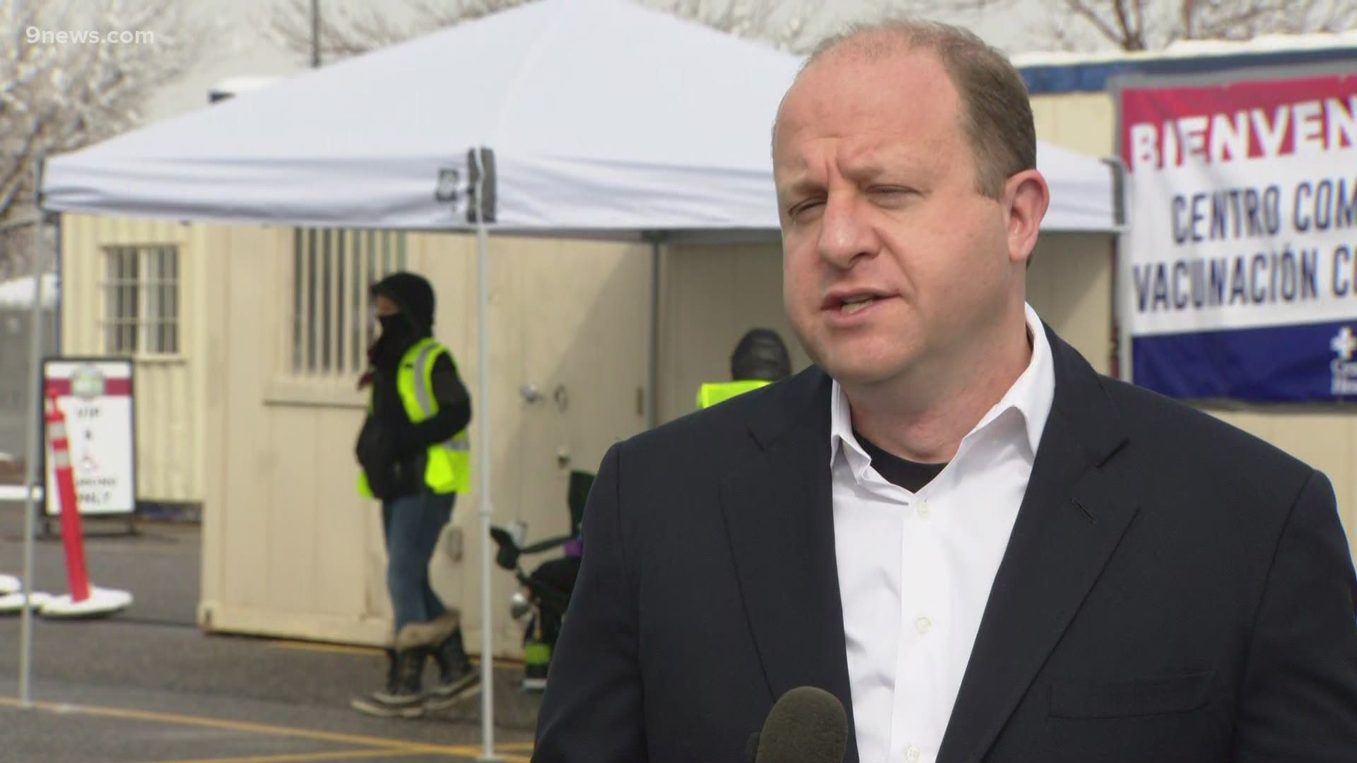 Gov. Jared Polis visited the new drive-through COVID vaccination site at Dick’s Sporting Goods Park in Commerce City on Monday.