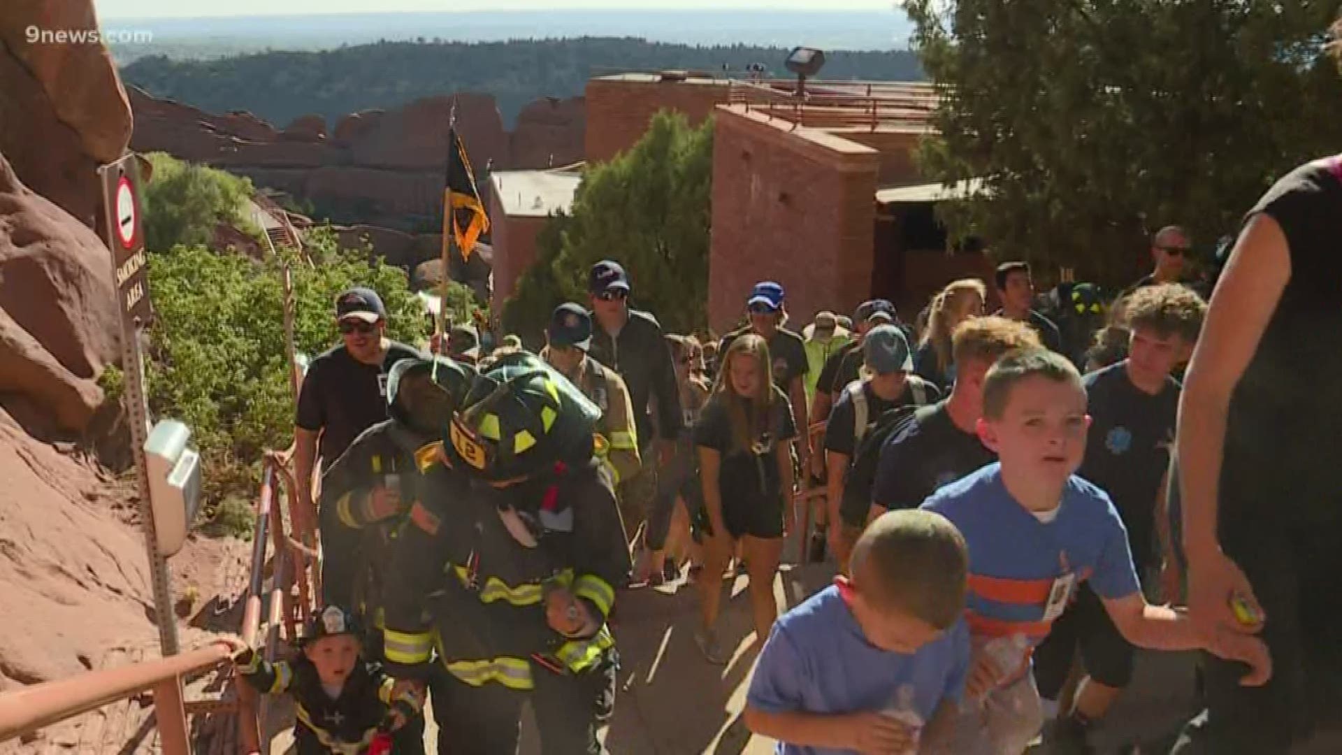 The event takes place at Red Rocks Amphitheatre. Firefighters and community members climb the stairs to honor the New York firefighters who died on September 11, 2001.