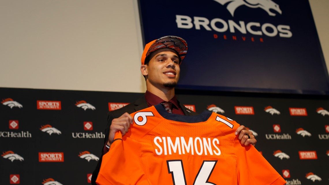 Former Colorado State offensive lineman Ty Sambrailo, the Denver Broncos  second-round pick in the NFL Draft, holds up his new jersey during a news  conference Saturday, May 2, 2015, in Englewood, Colo. (