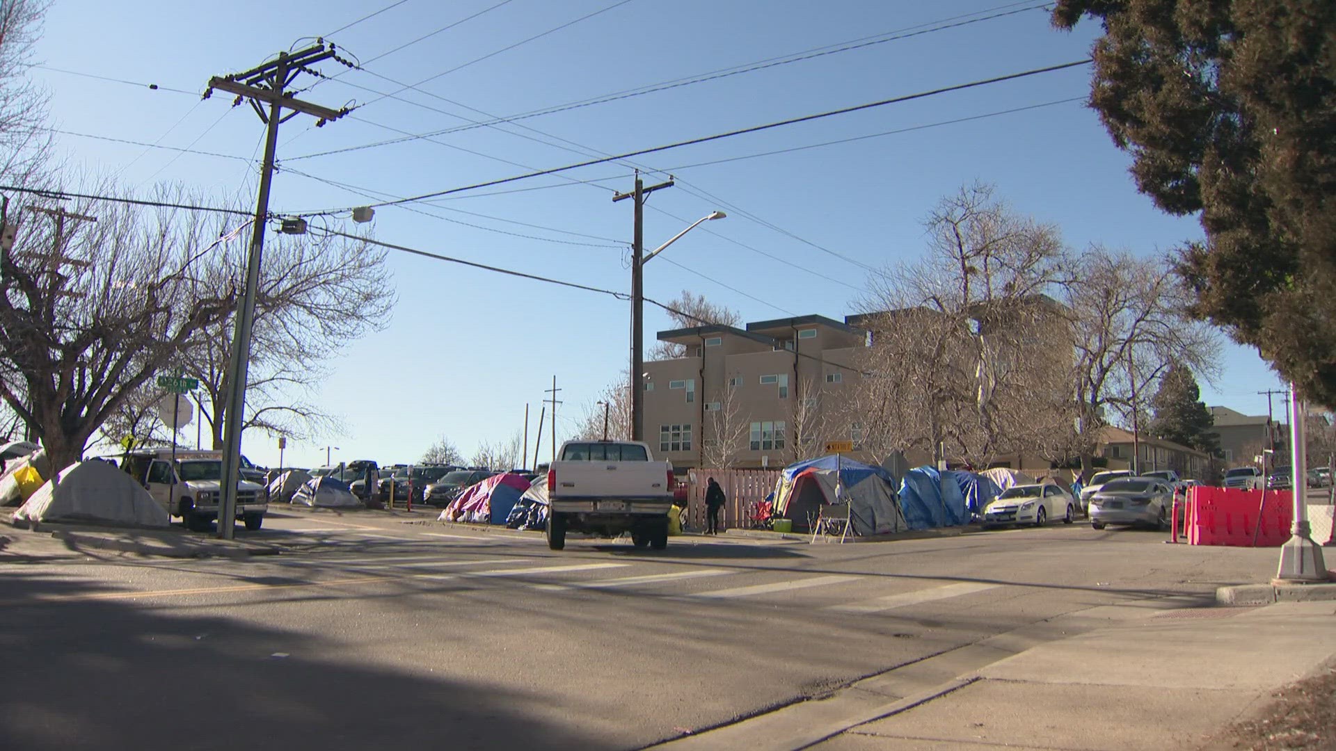 The homeless encampment on Speer Boulevard and Zuni Street is filled with hundreds of migrants who are no longer eligible to live in shelters.