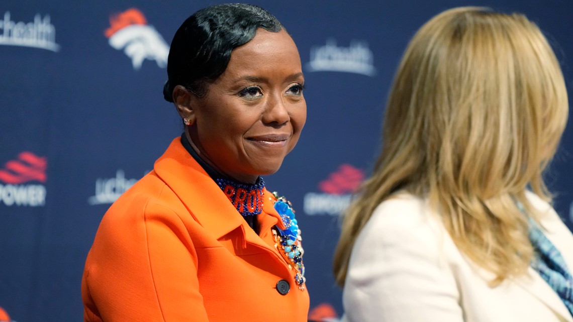 From left to right, Damani Leech, the new president of the Denver Broncos,  joins his daughters, Brianna and Simone, and wife Tamara for a photo after  an introductory news conference at the