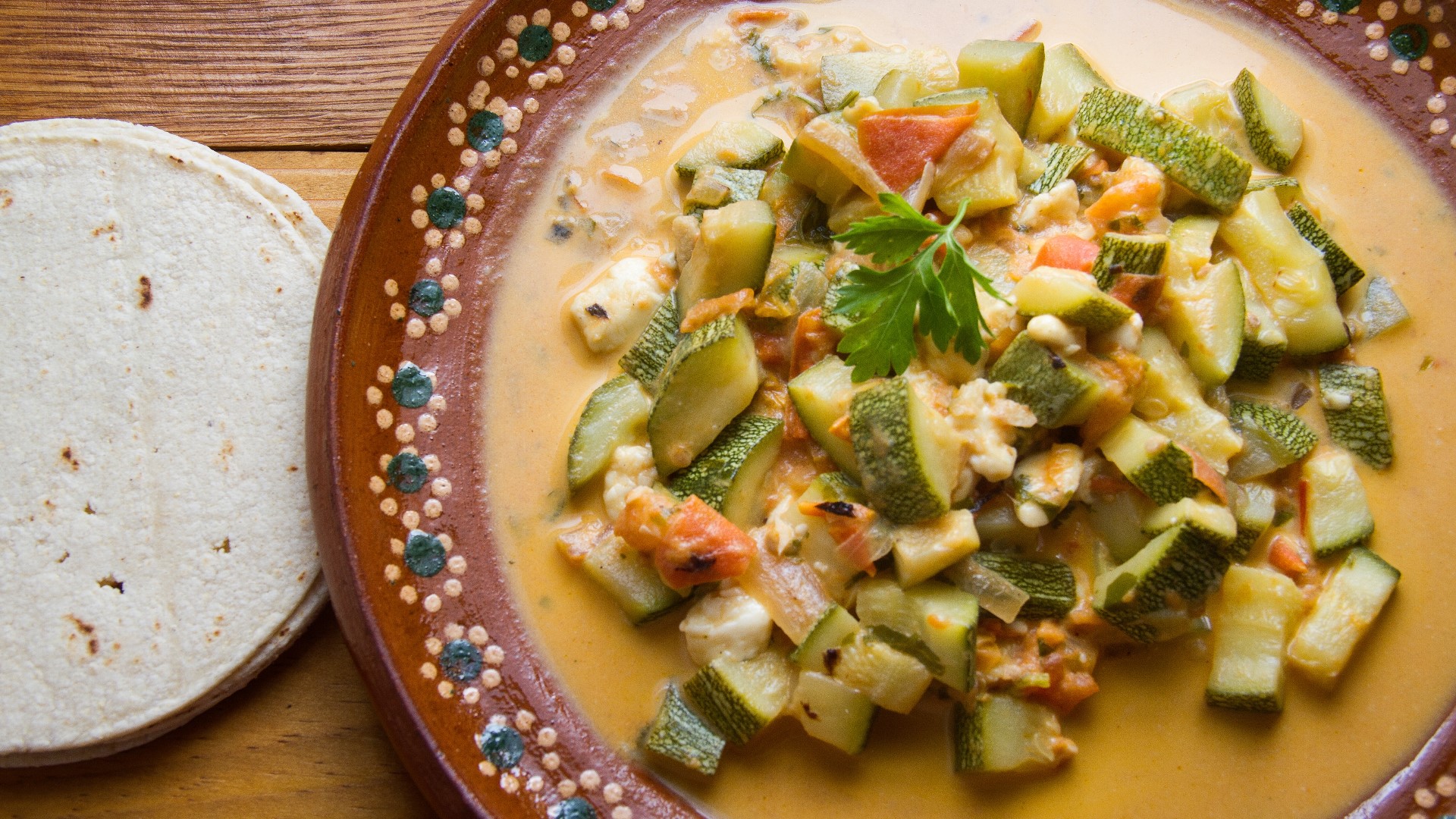 Calabacitas is a Mexican dish made from sauteed zucchini or squash, corn, tomatoes and peppers.