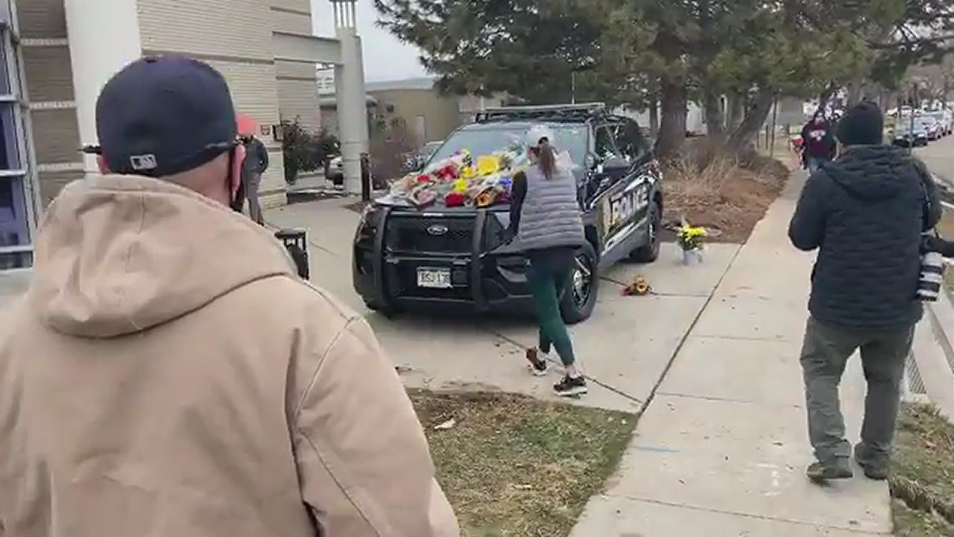 Members of the community are placing flowers on a Boulder patrol car out of respect for the fallen officer and the 9 other victims of Monday’s King Soopers shooting.