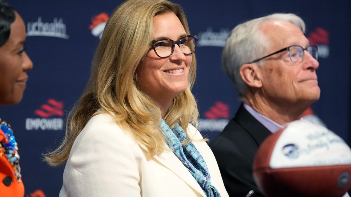 From left to right, Damani Leech, the new president of the Denver Broncos,  joins his daughters, Brianna and Simone, and wife Tamara for a photo after  an introductory news conference at the