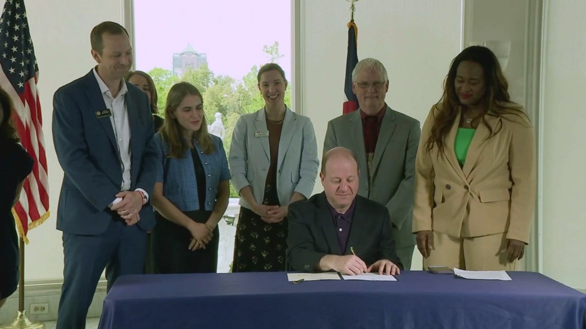 Colorado Democrats stand beside censured Polis at bill signings