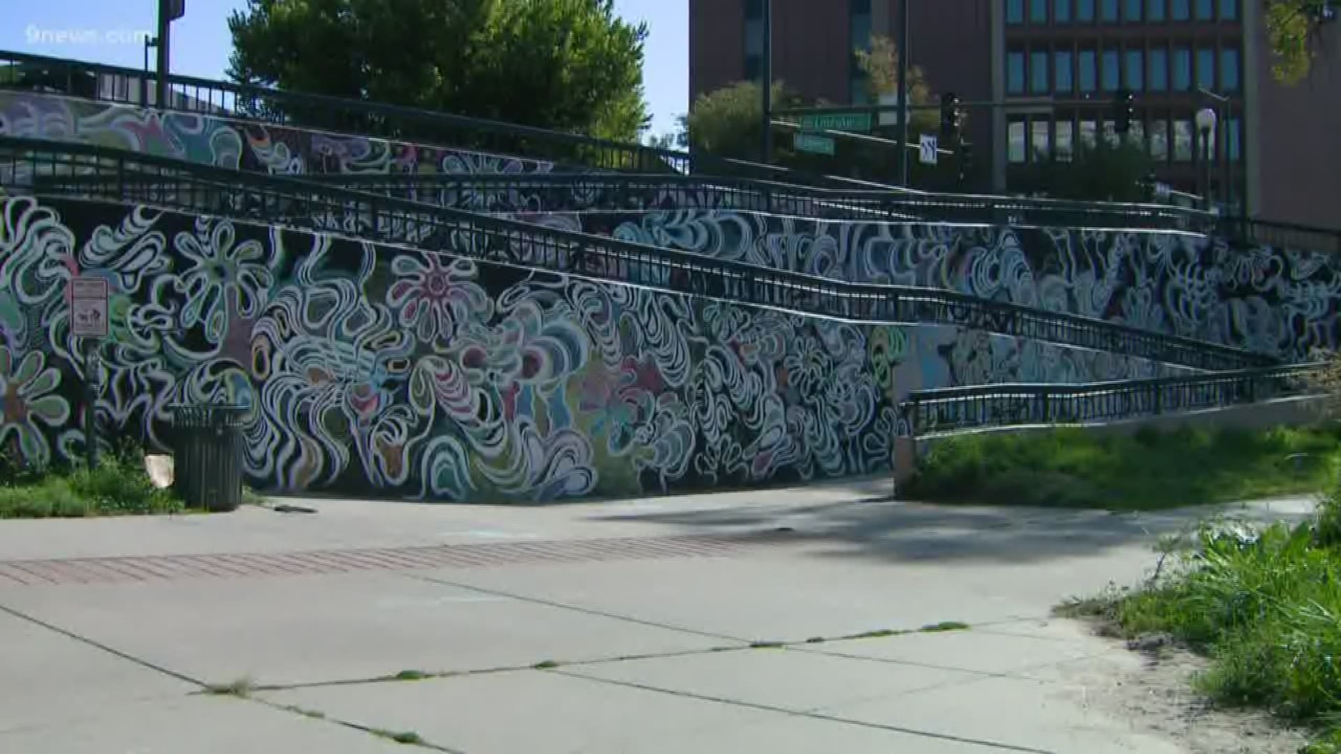 Markus Puskar painted the mural along the Cherry Creek bike path in all black and white. Passersby can color on it with chalk.