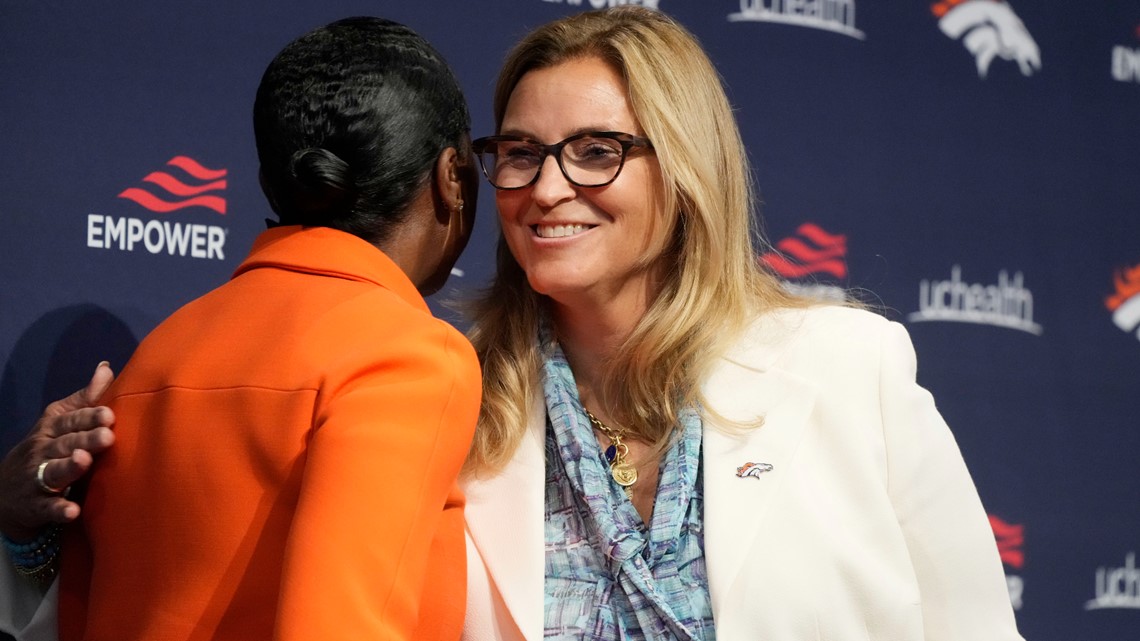 From left to right, Damani Leech, the new president of the Denver Broncos,  joins his daughters, Brianna and Simone, and wife Tamara for a photo after  an introductory news conference at the