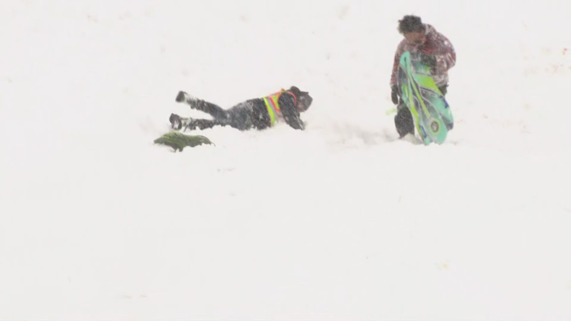 9NEWS reporter Steve Staeger took a spill while taking a break from clearing snow to go sledding with some high schoolers.