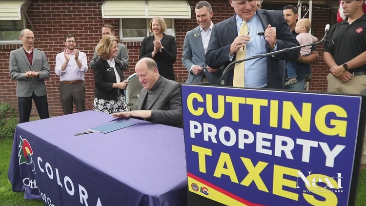Polis signs property tax relief measure as opposition mounts